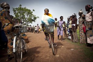 A person from Ghana riding a bicycle